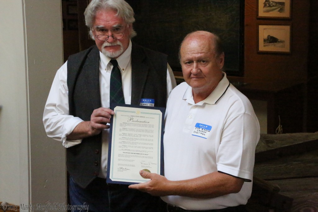 Richard Sims, Director of the New Mexico Historic Sites presents Joe Bacca a proclamation from New Mexico Governor Susana Martinez proclaiming October 22, 2013 as Dawson Remembrance Day.