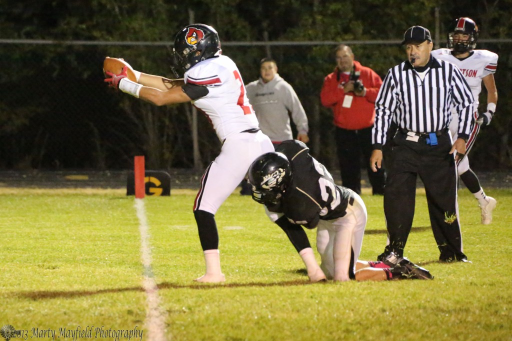 Dominic Lucero leans over the goal line as Raton's Caleb Wood gets dragged along