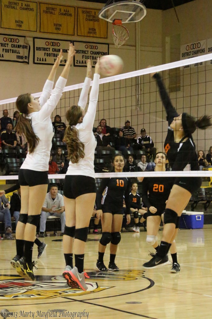 Alyssa Buzzuto sets the spike as Leah Cimino makes the block with Kristina Jansen assisting