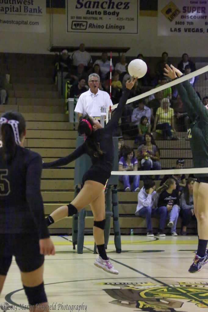 Kalista Dorrance gets the tip back over as Caelin Bustos sets up for the block. 
