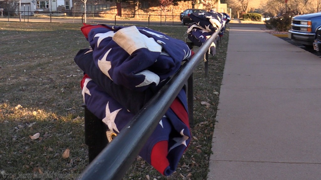 Folded flags awaiting to be put up at the Colfax County Building Monday morning