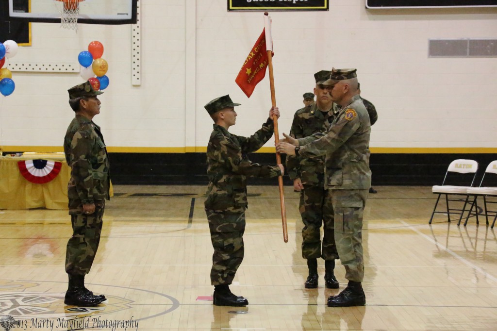 Young Marine Rochelle Jackson was promoted to Private First Class and was also awarded the Commander's Trophy for her outstanding efforts during basic training. Here she is given the guidon for the platoon. 