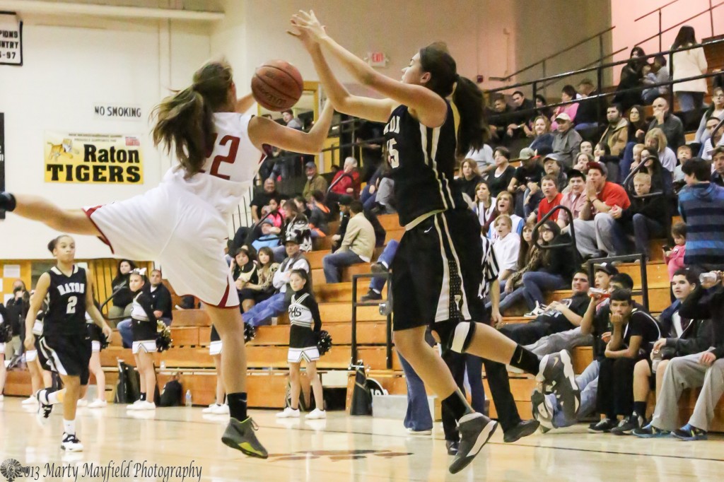 Gentry Houkebo flies in front of the pass to Tarryn Trujillo Friday night in tiger Gym at the 77th Annual Cowbell Tourney