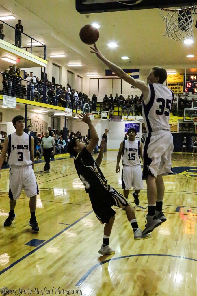 Rye's big man gets up well above Dylan Query and his shot during the tight game Saturday night in Scott Gym