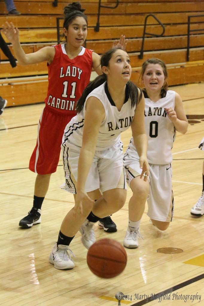 Sophia Madelini heads for the basket during the JV game Thursday evening in Raton as Tate Wood (0) and Kametha Martinez (11) look on.