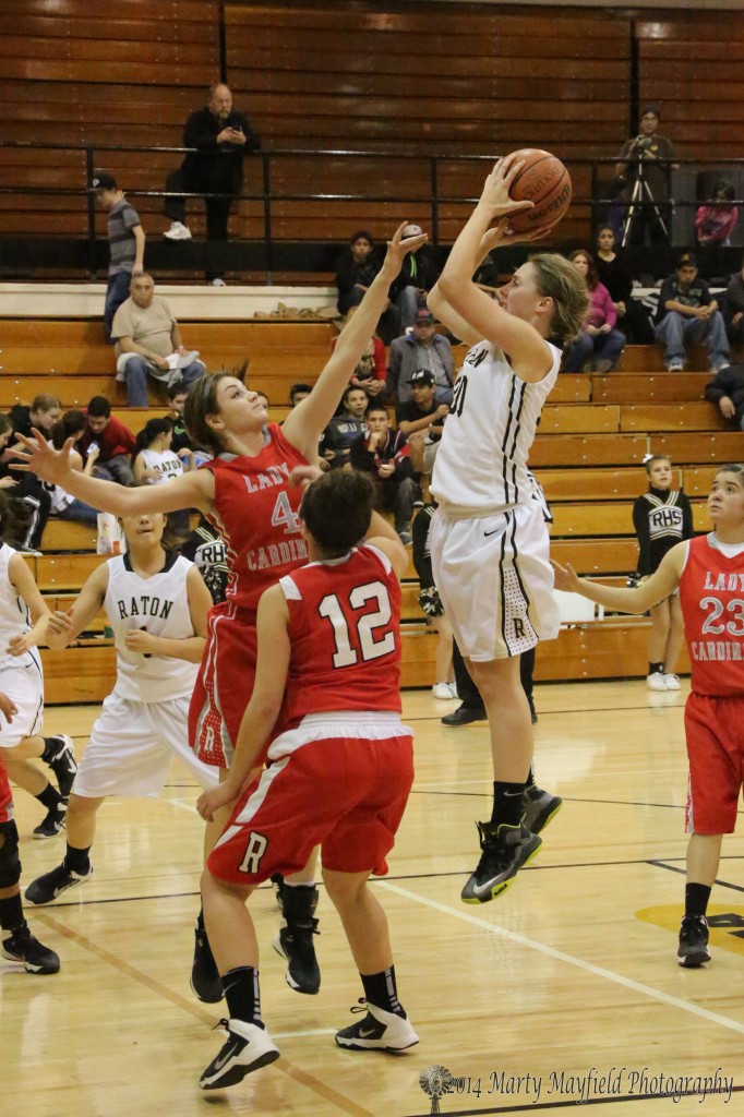 Mikala Vertovec puts up the jumper as Abby Bradley goes for the block Thursday night 
