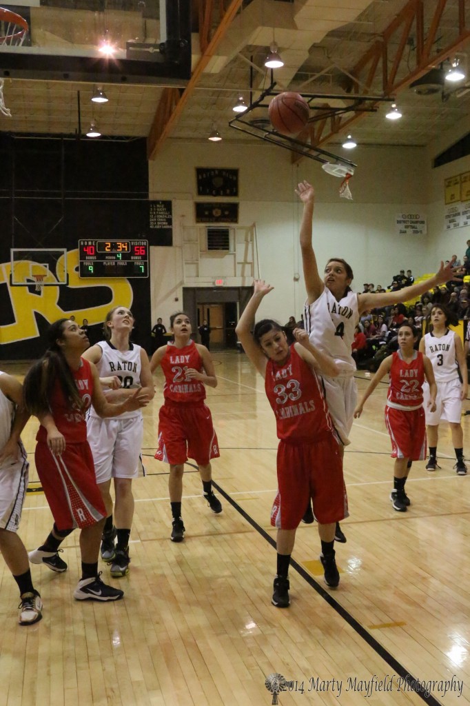 Breanna Pais goes up high for the shot as she finds Celeste Trujillo in her way Thursday night in Tiger Gym.