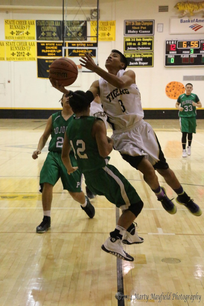 Tiger Jonathan Cabrieles drives to the basket as Elk Chris Fierro draws the foul