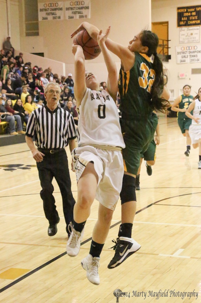 Jenna Bustos(32) pounds the ball out of Tate Wood's hands as she headed up for the basket Thursday evening in Tiger Gym