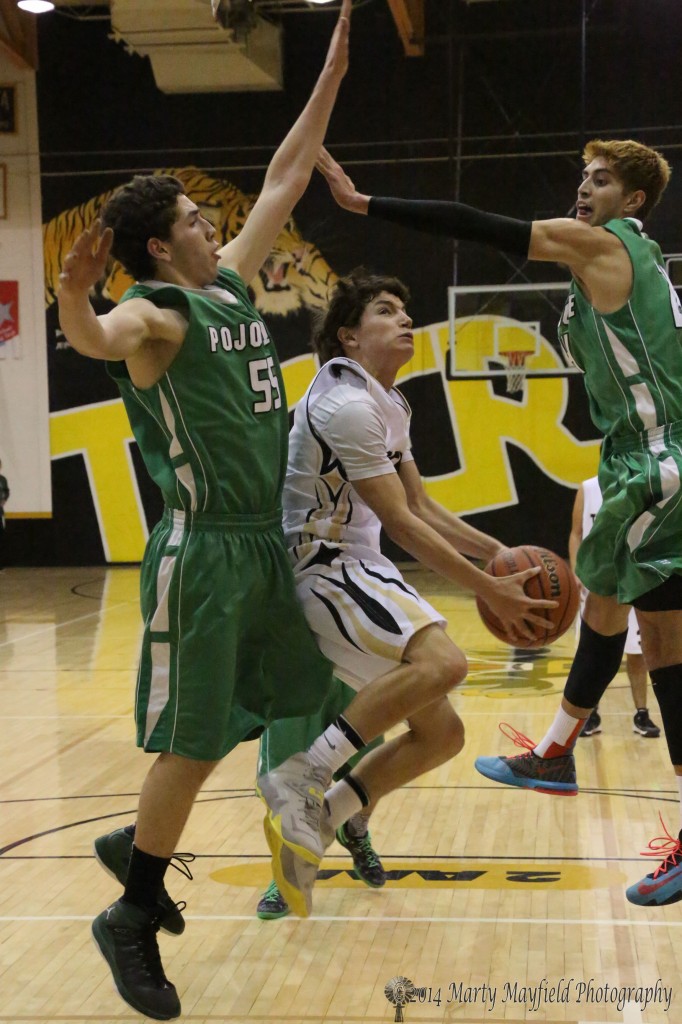 Dylan Query flies toward the basket as Elk Chris Cordova and Matthew Herrera go for the block. 