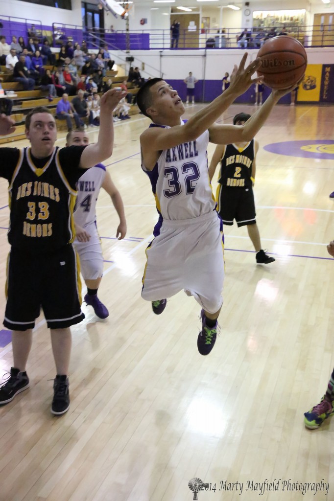 Devon Cruz Flies through the air on his way to the basket during the Maxwell Des Moines District game in Maxwell