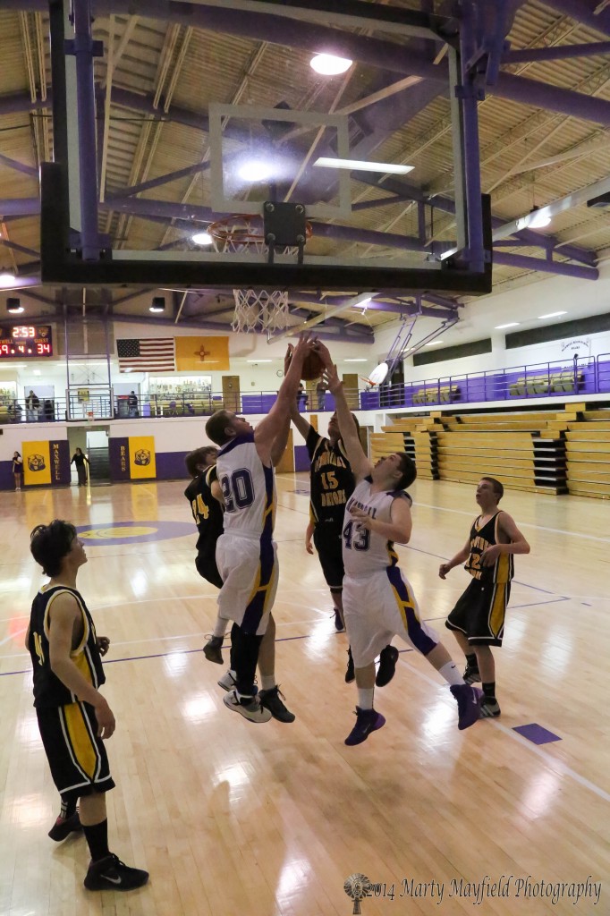 A scramble for the rebound as Maxwell's Thomas Casper (20) and Tyler Hightower (43) along with Des Moines AJ Wright (24) and Tristen McNabb (15) get hand on the ball.