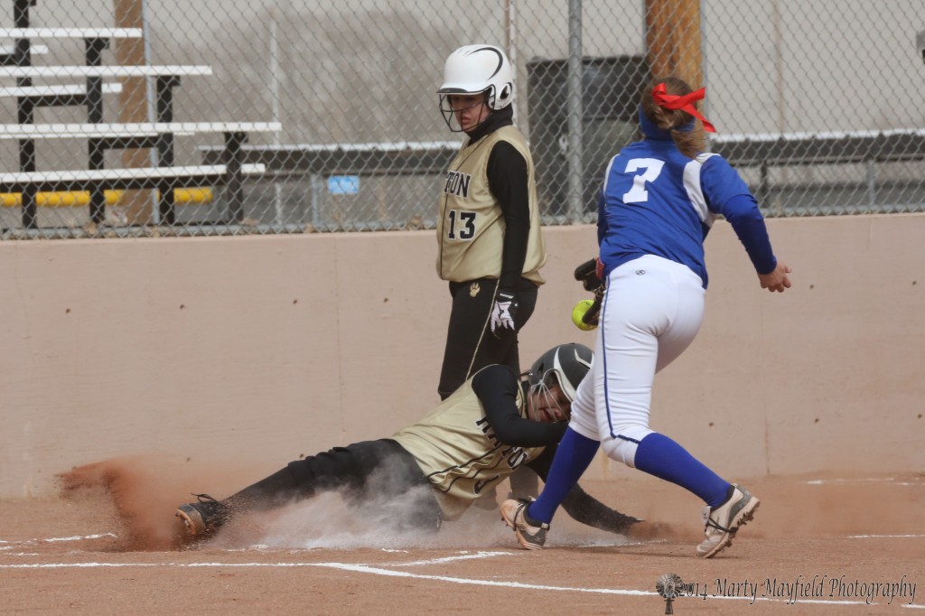 Shania Dorrance slides home for one more Raton score as the ball just misses Allie Burhost's mitt for the tag.