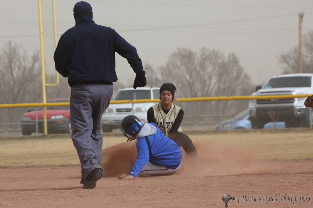 A St Mikes player slides safe into second just ahead of the ball.