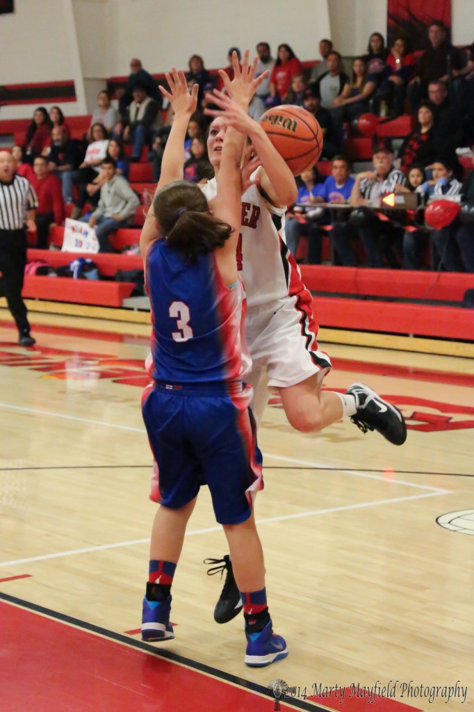 Anjelica Montoya gets an oops there goes the ball as she runs up against Karla Santos Friday night in the first round of state tourney play.