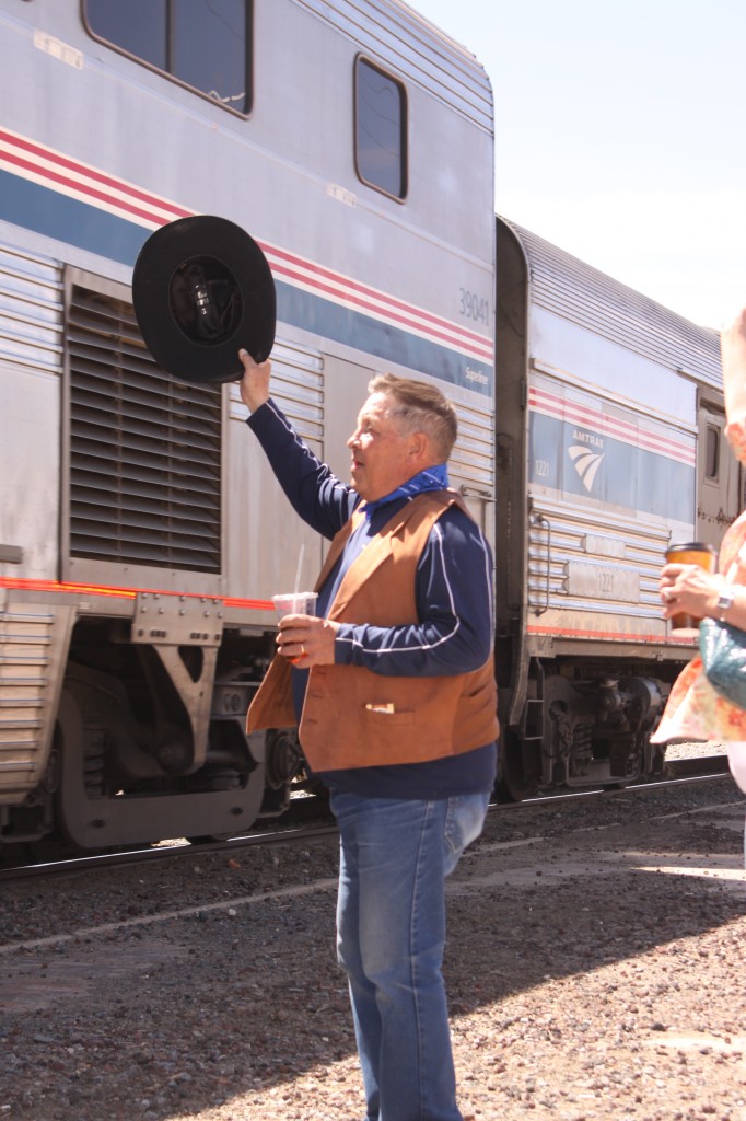 City Commissioner Ronald Chavez, waves the train into Raton in his best western wear. Photo By Matt Mayfield