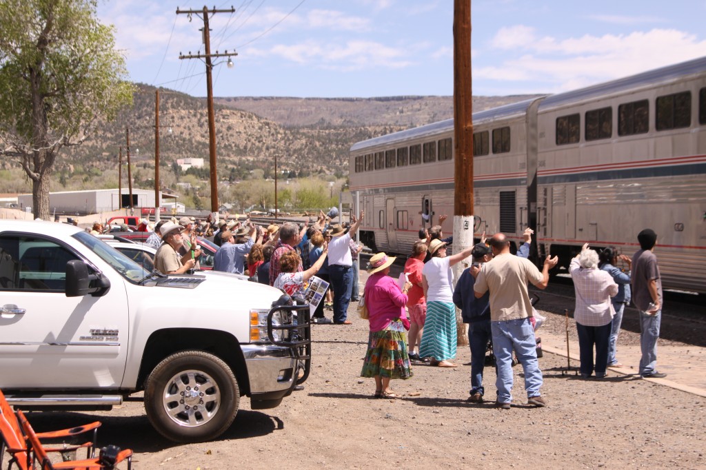 Locals wave the Train onward as it pulls from Raton’s historic train stop. Photo by Matt Mayfield