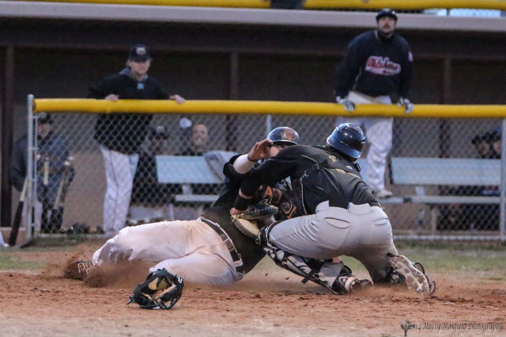 Chris Williams is tagged out at home plate.