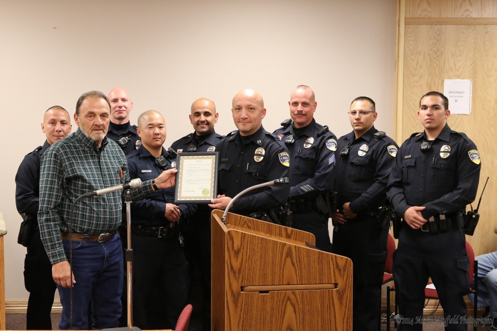 Orlando Avila, Derek Hightree, John Hong, Nolberto Dominguez, Capt John Garcia Sgt James Valdez, John Valdez, and James Haught accept the proclamation from commissioner Don Giacomo for National Police week recognizing the work and sacrifices that the officers put forth to protect the community. 