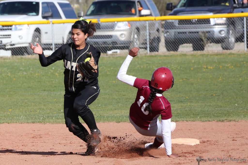 Sandia Prep player slides in just under as Natasha Archuleta reaches out for the ball