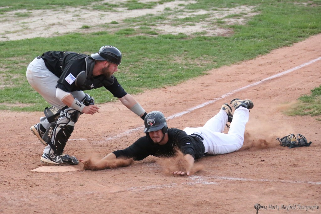 Just inches from home plate comes the tag as Chris Williams slides wide hoping to be missed by Trigger Catcher Nicholas Bruce