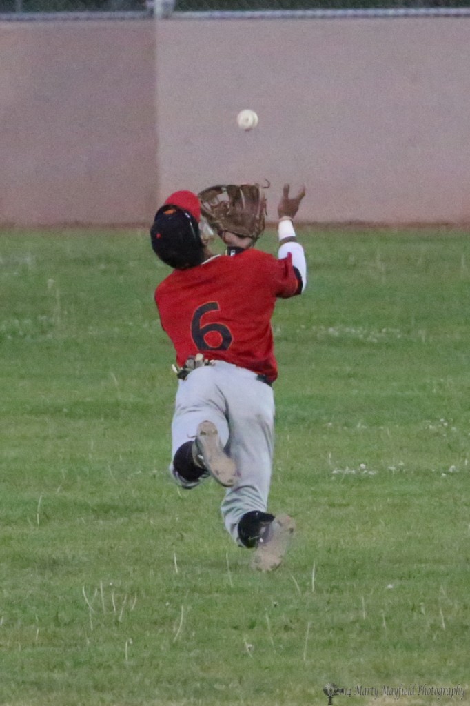 Omar Artsen makes a running leap for the ball just coming over his shoulder late in the game Tuesday evening at Gabriele Field