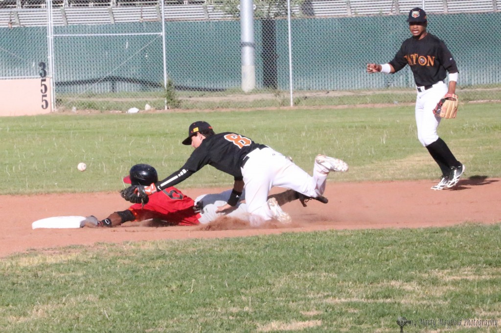 Omar Artsen slides safe into second base as shortstop Aaron Olivas looses the ball in the collision Wednesday evening.