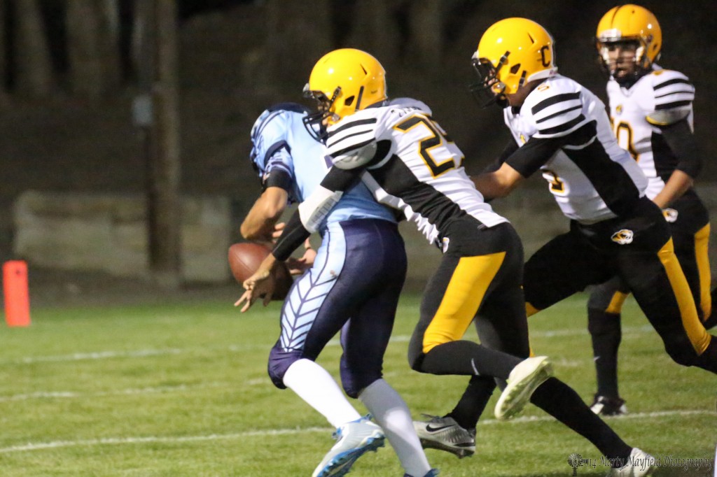 Jonathan Cabrieles gets a hand on the ball and frees it from quarterback Vince Ferraro 