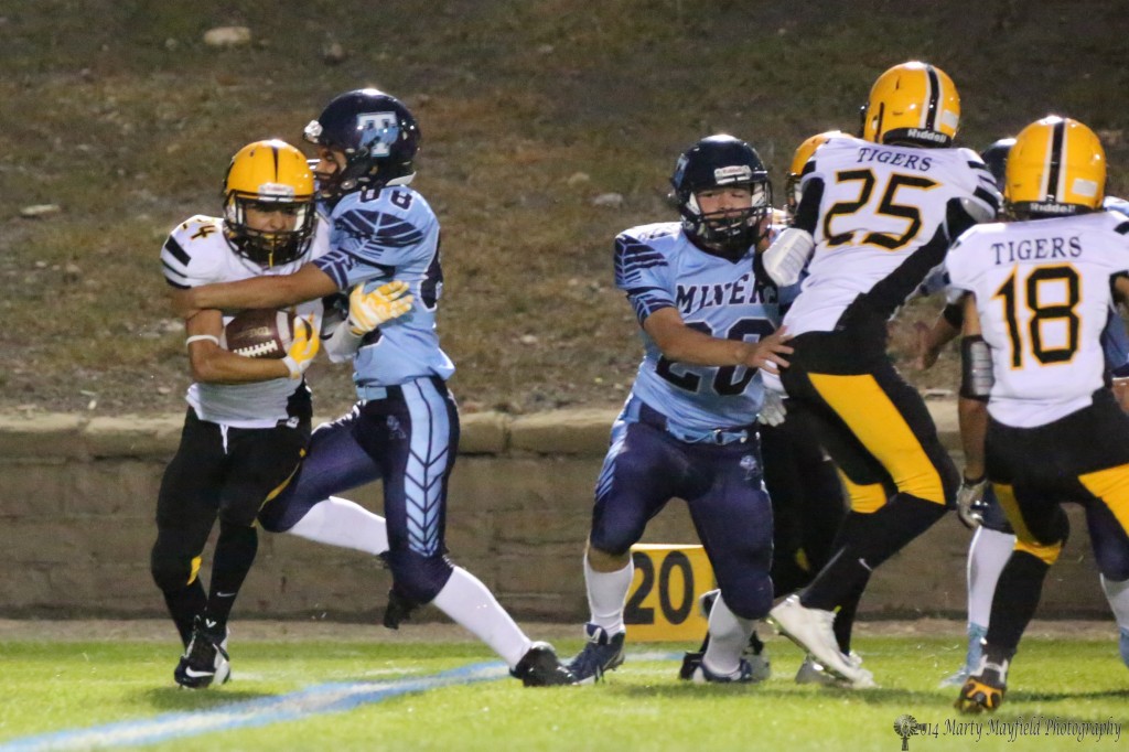 Oscar Areola gets caught by a bigger Josh Noriego on a kickoff return Friday night in Trinidad.
