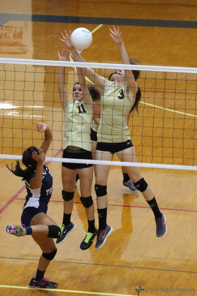 Kristina Jansen and Camryn Mileta go up for the block and Kristina gets it back over for the point 