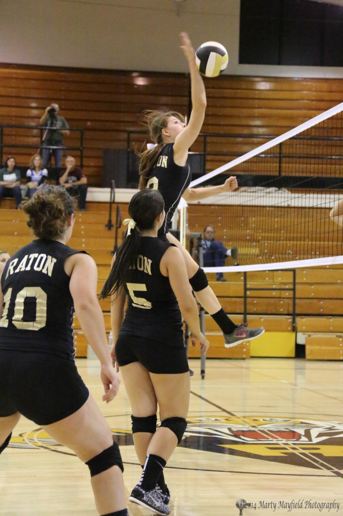 Kristina Jansen gets up and meets the ball as she slams it back over the net Saturday afternoon against Espanola Valley