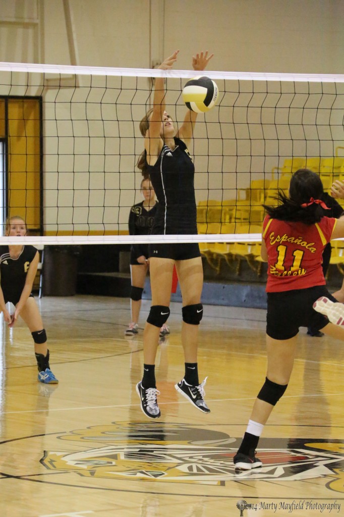 Alina Pillmore makes the block against Espanola Valley's Cheyanne Martinez Saturday afternoon in the fourth game of the match