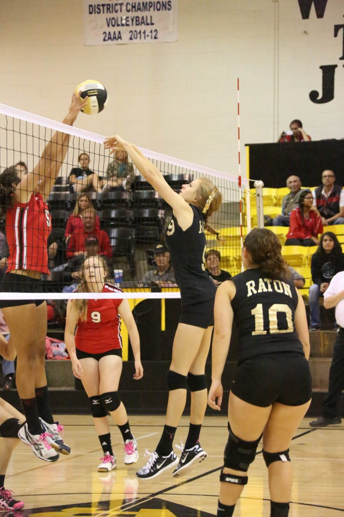 Lady Redskin's Rena Trujillo get the block after Alina Pillmore sent the ball over the net.