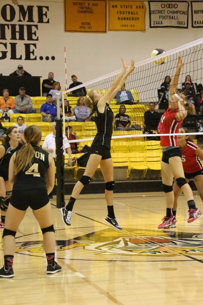 Shaylee Andreatta puts the ball in the net as Alina Pillmore goes for the block