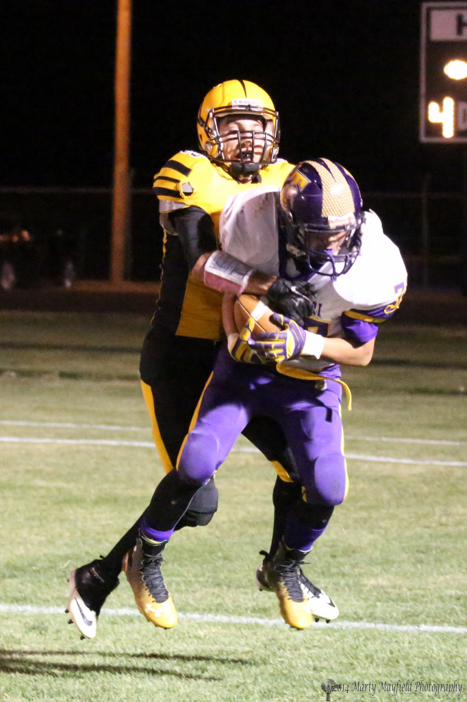2 of 5,   Daniel Lopez makes the interception late in the game Friday night but the call was incomplete pass,  here Martin Ortiz gets his hand on the ball and as you will see starts to pull it out and will have it out of bounds after the play