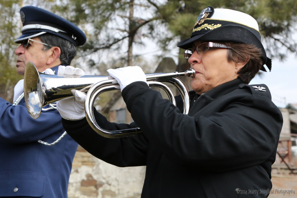 Colonel Edna Candelario plays "Taps" during the dedication of Veterans Park Tuesday morning. 