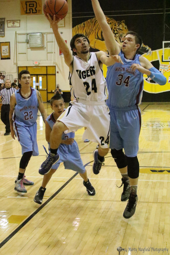 Connell Ware (24)goes up against Danny Gray(34) during the third place game in the 78th Annual Cowbell Tourney in Raton.  