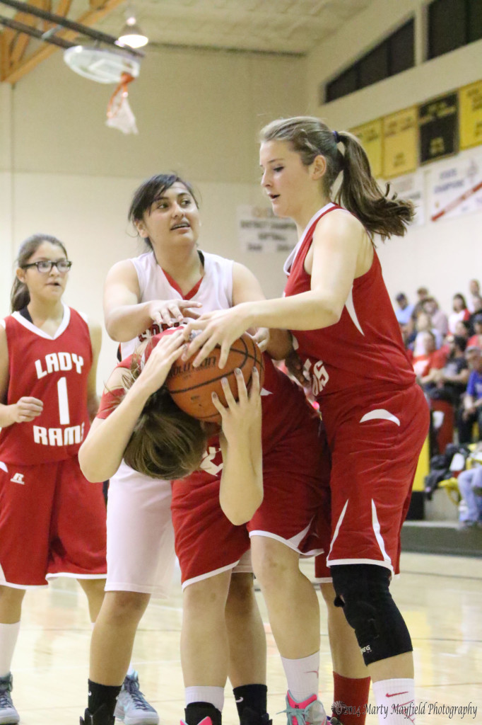 Lady Red Devil Shania DeHerrera and Lady Ram Gentry Huckaboo go for the ball that Jessica Pittman now has on her head. 