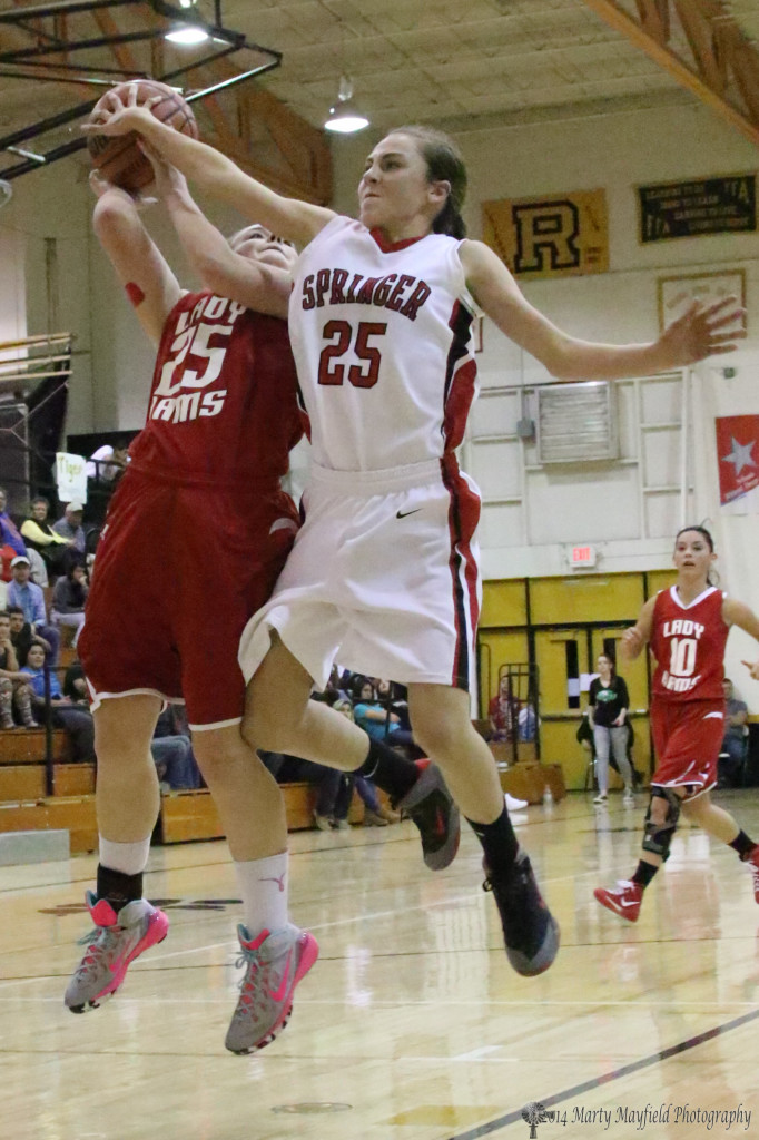Hannah Burton (25) gets a hand on the ball as Jessica Pittman (25) goes up for the shot in the championship game.