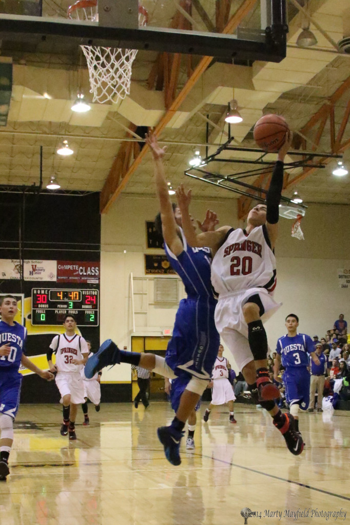 Anthony Romero (20) goes up for the lay-up as Thomas Madrid goes for the block during the 78th Annual Cowbell Tourney 