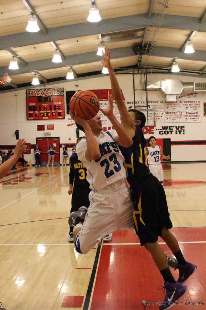 Maxwell's Carl Gonzales goes for the block as Zack Gallegos goes for the layup Wednesday evening at the 2014 Cowbell