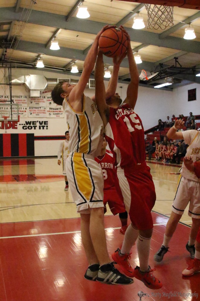 Preston Ogle and Jacob Subrate tie for the rebound during their game in the 2014 Cowbell Tourney