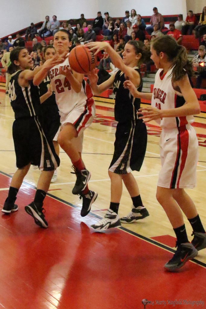 Angelica Montoya drives the lane as she did so many times Thursday night, this time however Daisy Earle (20) got a hand on the ball and the foul while Camryn Mileta is there to help out and Hannah Burton Looks on.