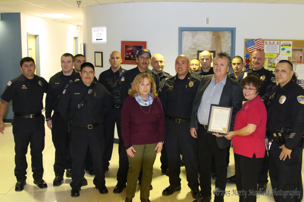 First Responders were honored with a proclamation of appreciation for their work in saving one of their own. Ricco Trujillo, a city employee, suffered a heart attack in August 2014 and credits his being alive today with the quick response by the Raton Emergency Services personnel. Dispatcher Valerie Monica holds the proclamation with Ricco Trujillo and Commissioner Lindé Schuster Raton Fire - FF Richard Garcia, FF Jacob Butt, FF Carl Ortiz, FF Edward Alcon, Cpt Anthony Burk, Deputy Chief Chris Espinoza, Police Dept -  Chief John Garcia, Sgt James Valdez, Ofc Orlando Avila, Ofc John Valdez, Ocf Andrew Sanchez, Ofc Scott Vinson, Dispatchers Carol Baca and Valerie Mojica.