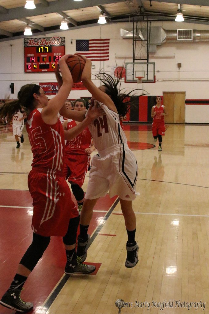 Again Kippi Webb uses her height advantage to give Anjelica Montoya fits as she tries for the shot late in the first quarter.