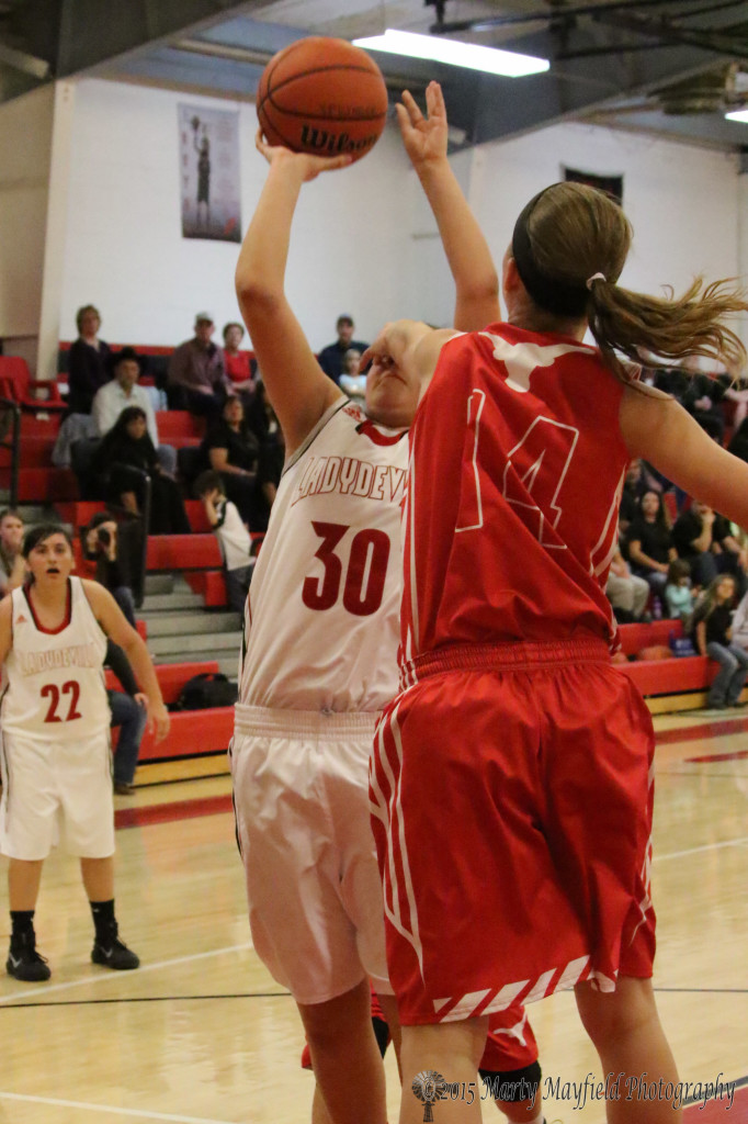 Alicia Arias takes one for the team as Kaylee Forre fouls Arias on the shot Saturday evening during the game with Logan