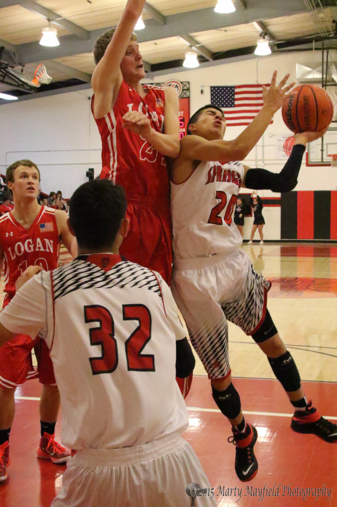 Wesley Gudgell head and shoulders about Anthony Romero goes for the block during the game Saturday night in Springer