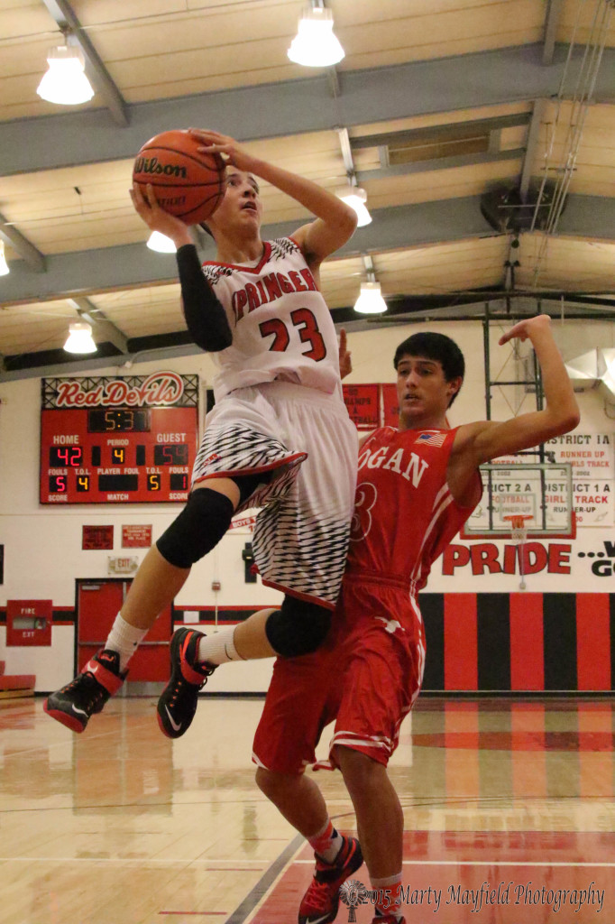 Trailing by 12 Estevan Romero makes the play to the basket as Mike Estrada backs out to prevent the foul. 