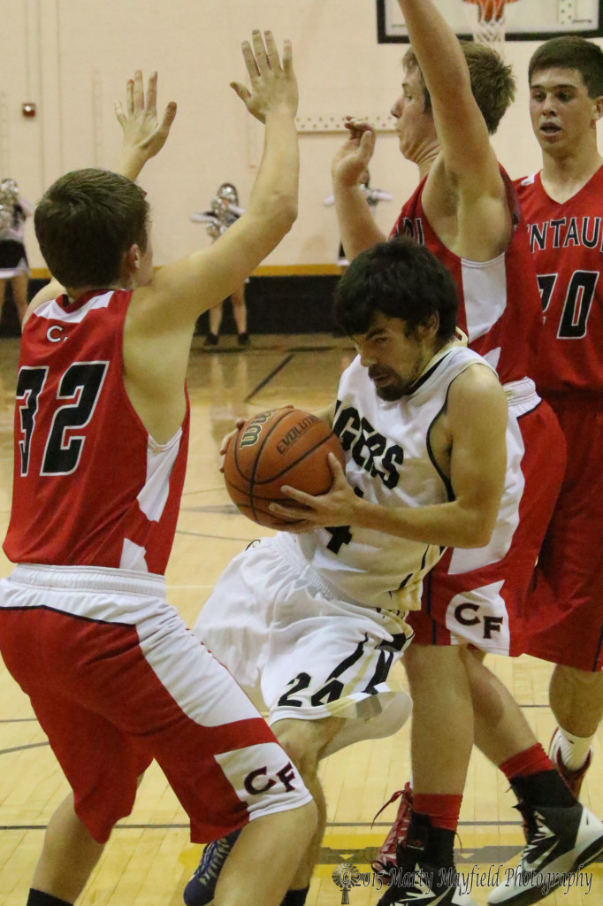 Connell Ware battles through the crowd toward the basket Tuesday evening against Centauri