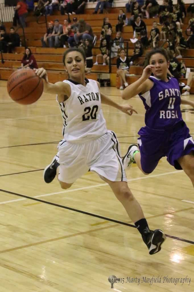 Daisy Earle (20) chases a long pass down court as Estrella Montoya (11) tags along during the JV game in Tiger Gym Friday night